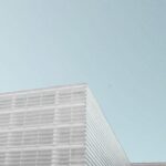 grey concrete building under clear blue sky